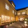 Inner courtyard of the Hotel Zum Schwarzen Bären with illuminated windows and plants at night.