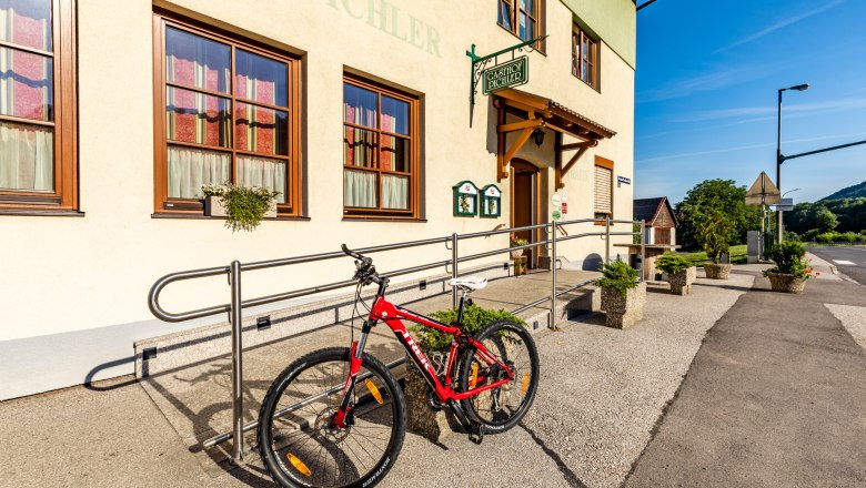 Bicycle in front of Gasthof Pichler on a sunny day.