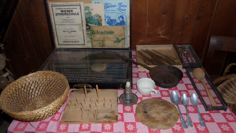 Table with old kitchen utensils and zither school books.