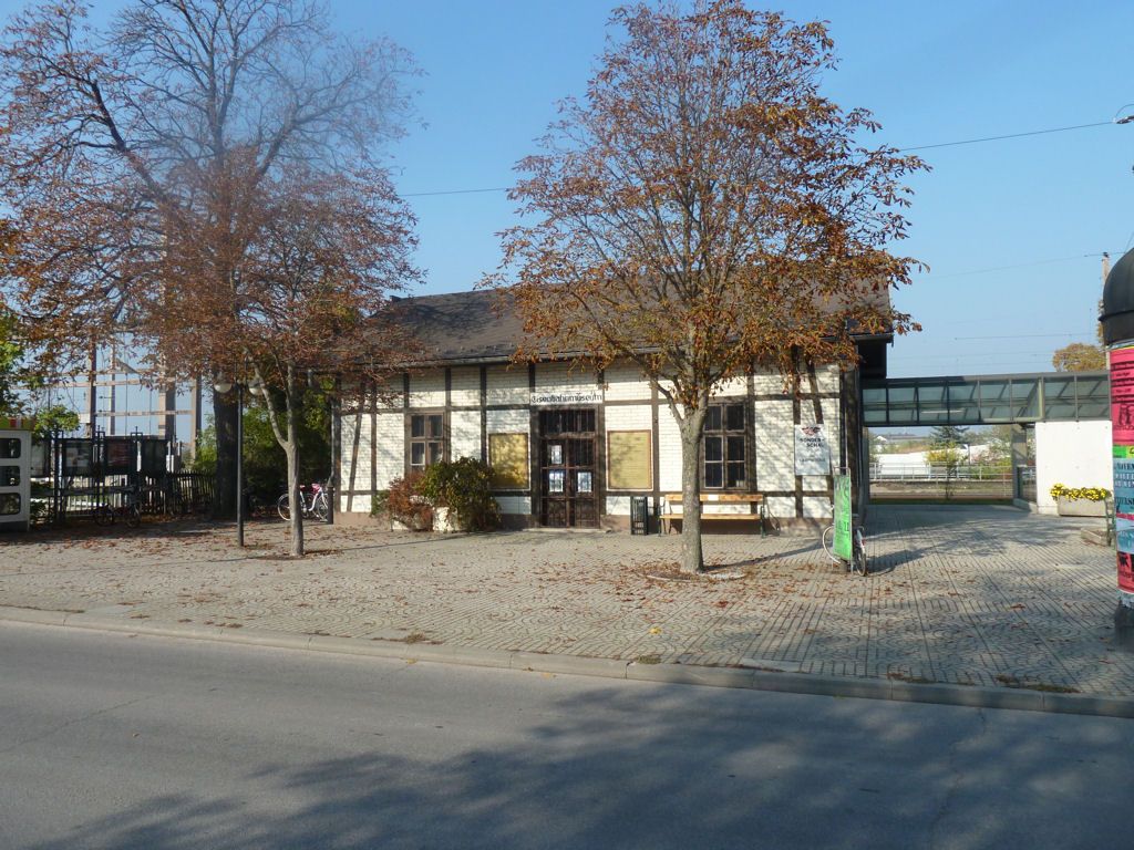 Old building of the Deutsch-Wagram Railway Museum with trees in the foreground.