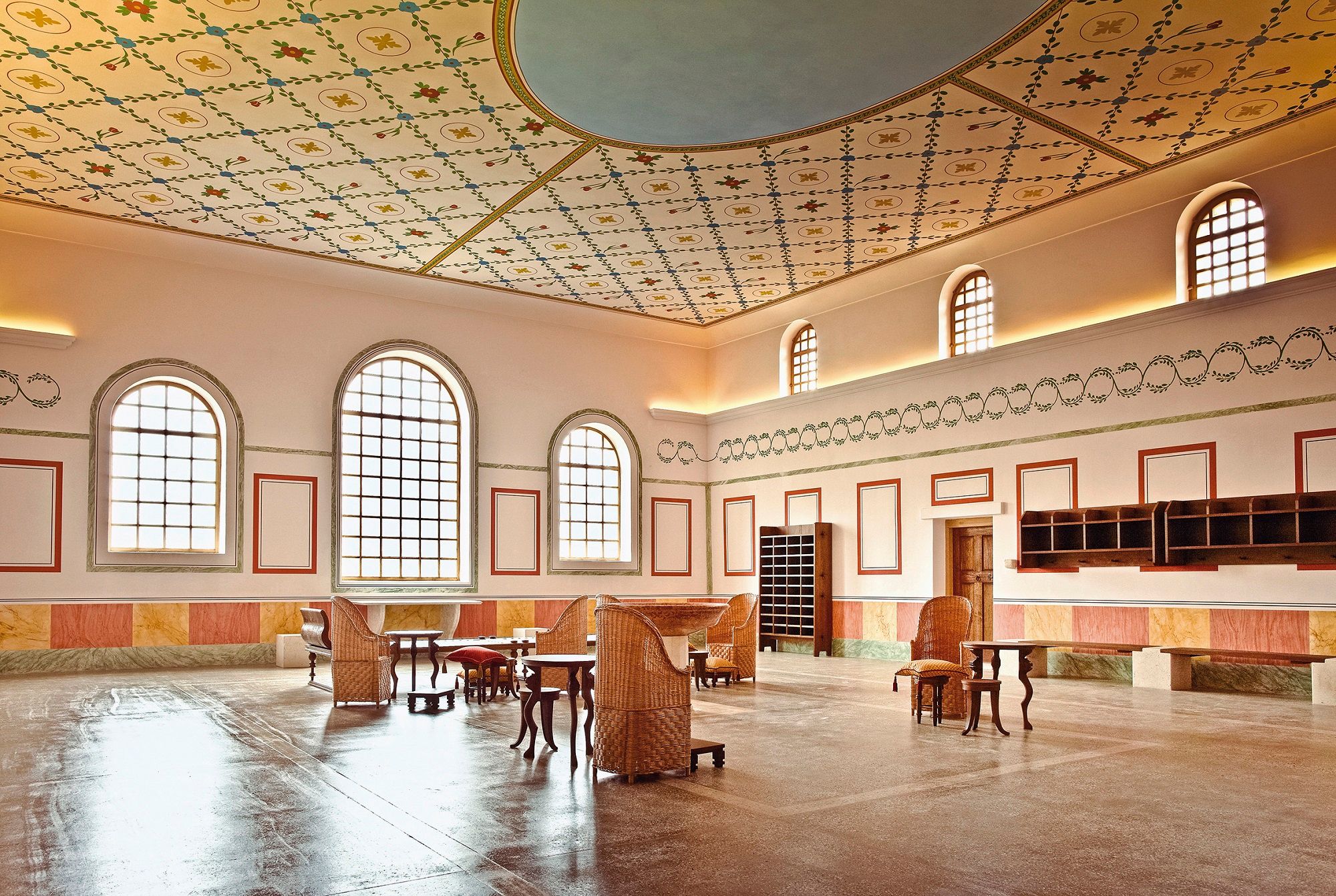 Interior view of the Roman town of Carnuntum thermal baths with decorative ceiling and antique furniture.