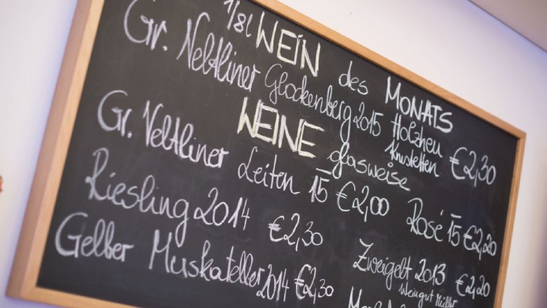 Table with wine selection and prices in a restaurant.
