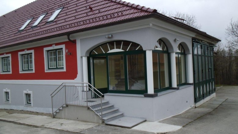 A modern building with a red roof and red façade.