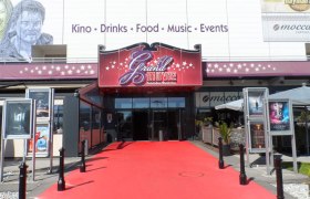 Entrance to the Grand Movie Cinema in Neunkirchen with red carpet.