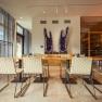 Interior view of a modern dining area with large amethysts on the wall.