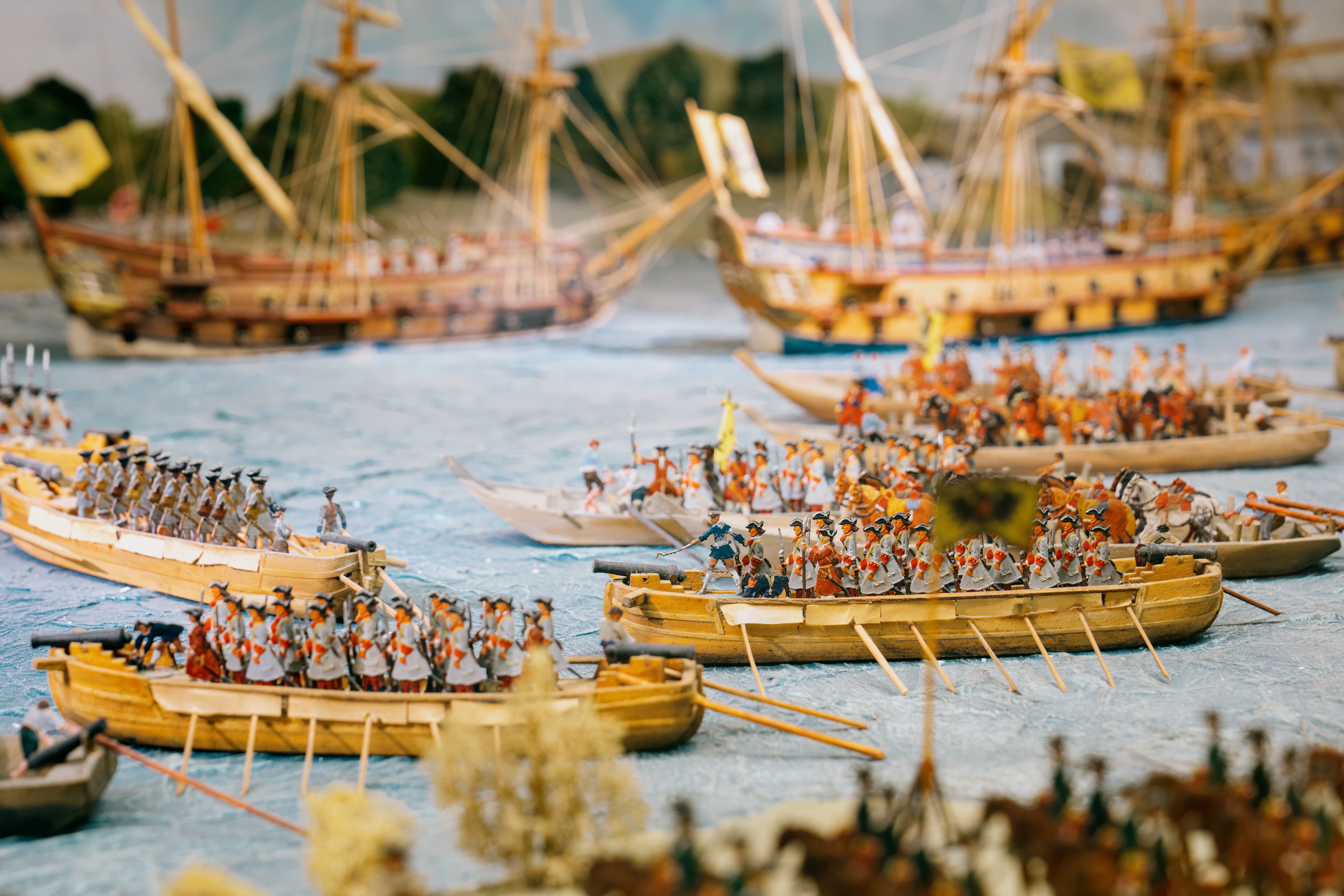 Close-up of pewter figurines depicting a historic naval battle.