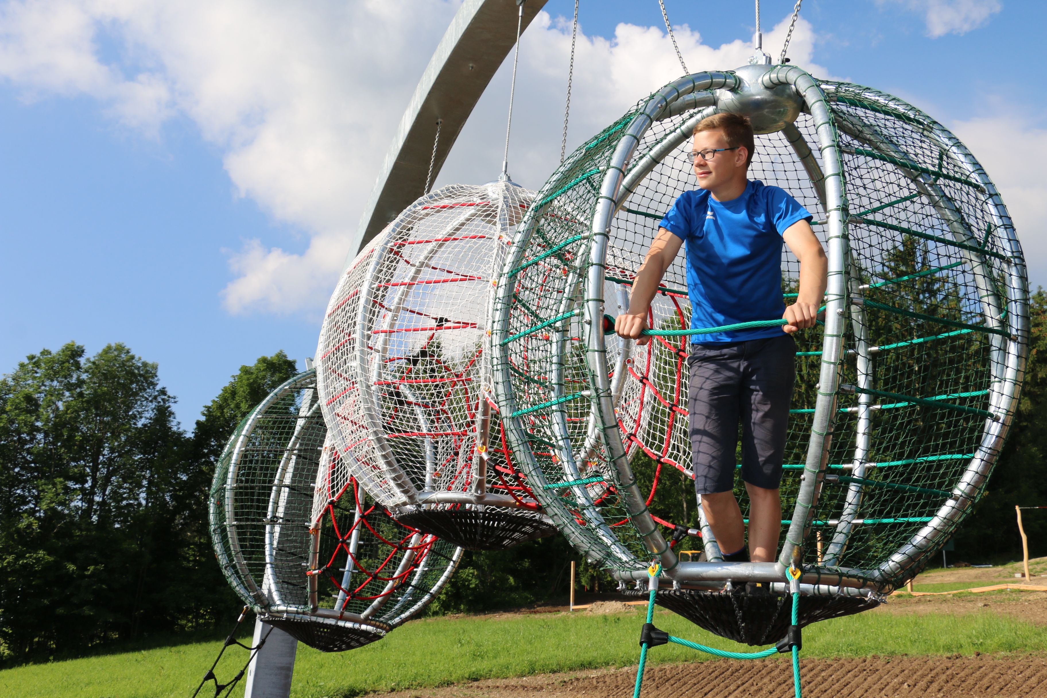 Person in a climbing frame in the motor skills park.