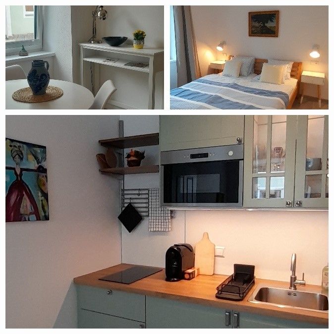 Interior view of a small apartment with dining area, bedroom and kitchen.