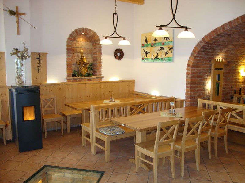 Cozy interior of a wine tavern with wooden furniture and brick arches.
