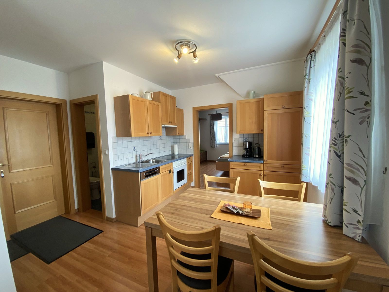 Interior view of a vacation apartment with kitchen and dining table.