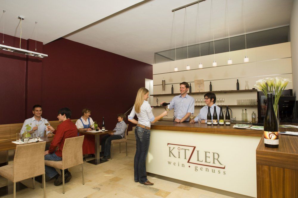 Interior view of a wine bar with guests and staff.