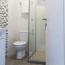 Modern bathroom with toilet, shower and towel rail.