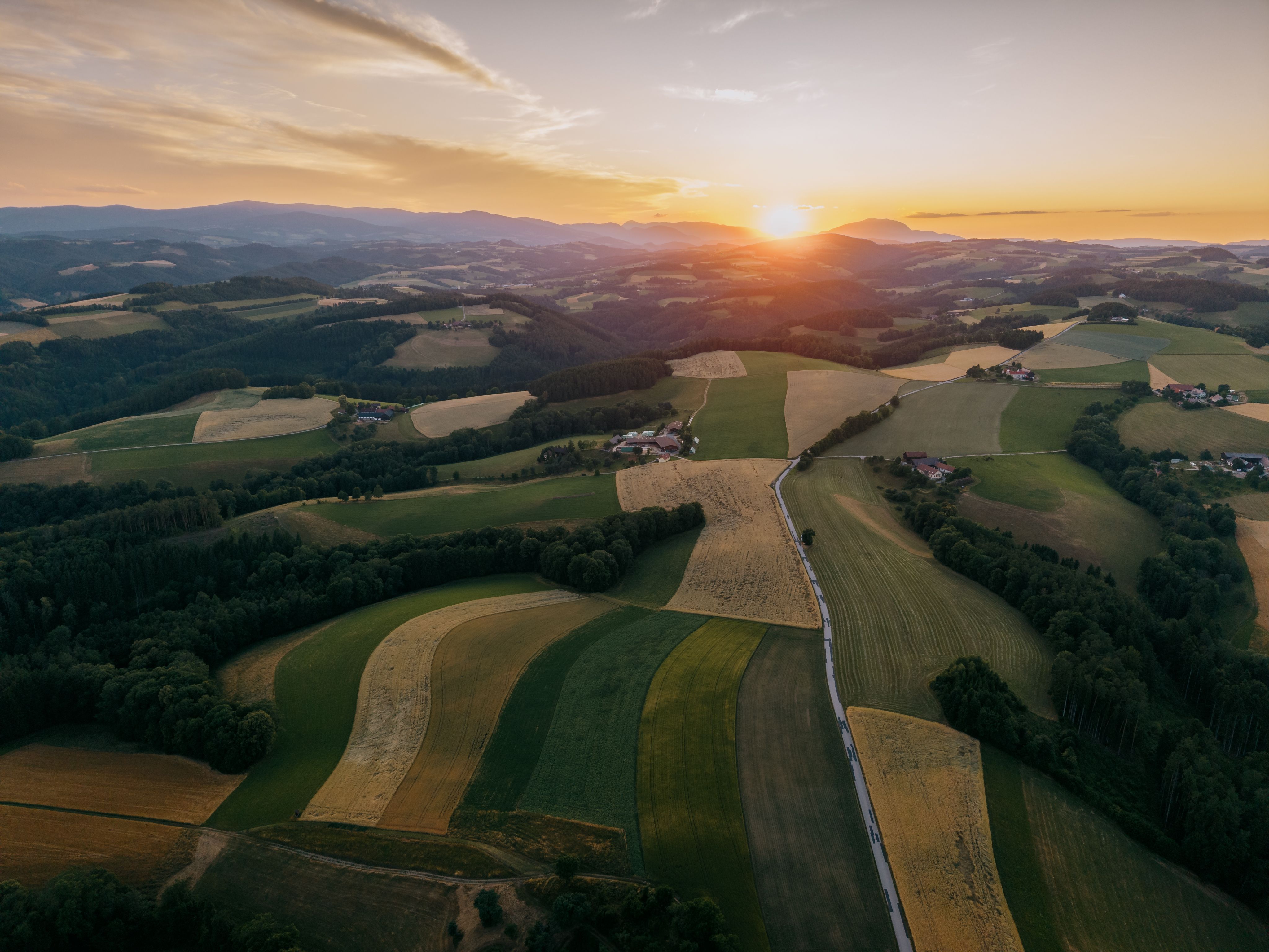Aerial view of a hilly landscape at sunset