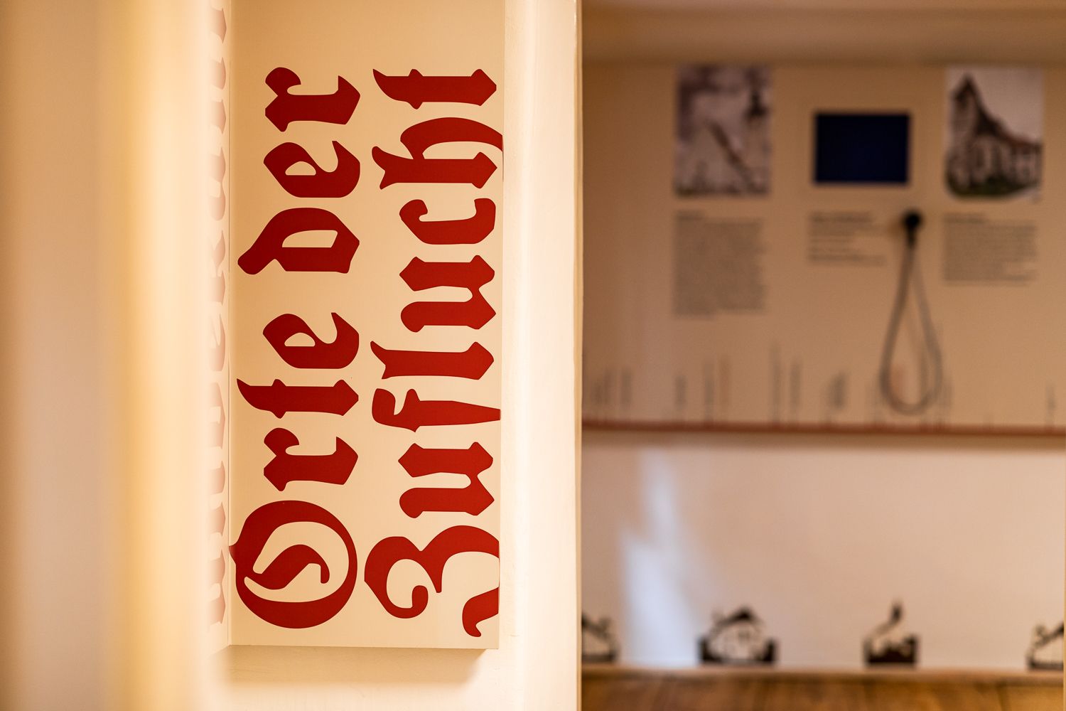 A sign with the inscription 'Places of Refuge' in the exhibition.