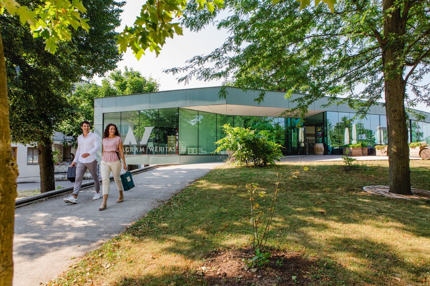 Couple in front of the local wine shop, with purchases in hand.