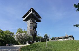 Buchbergwarte tower on a hill with blue sky in the background.
