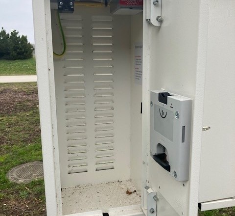 Open e-bike charging stations outdoors with empty interior.