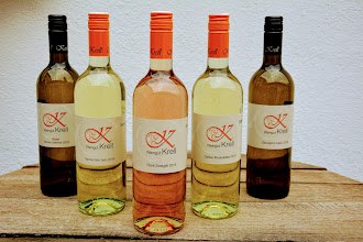 Five bottles of wine from the Krell winery on a wooden table.