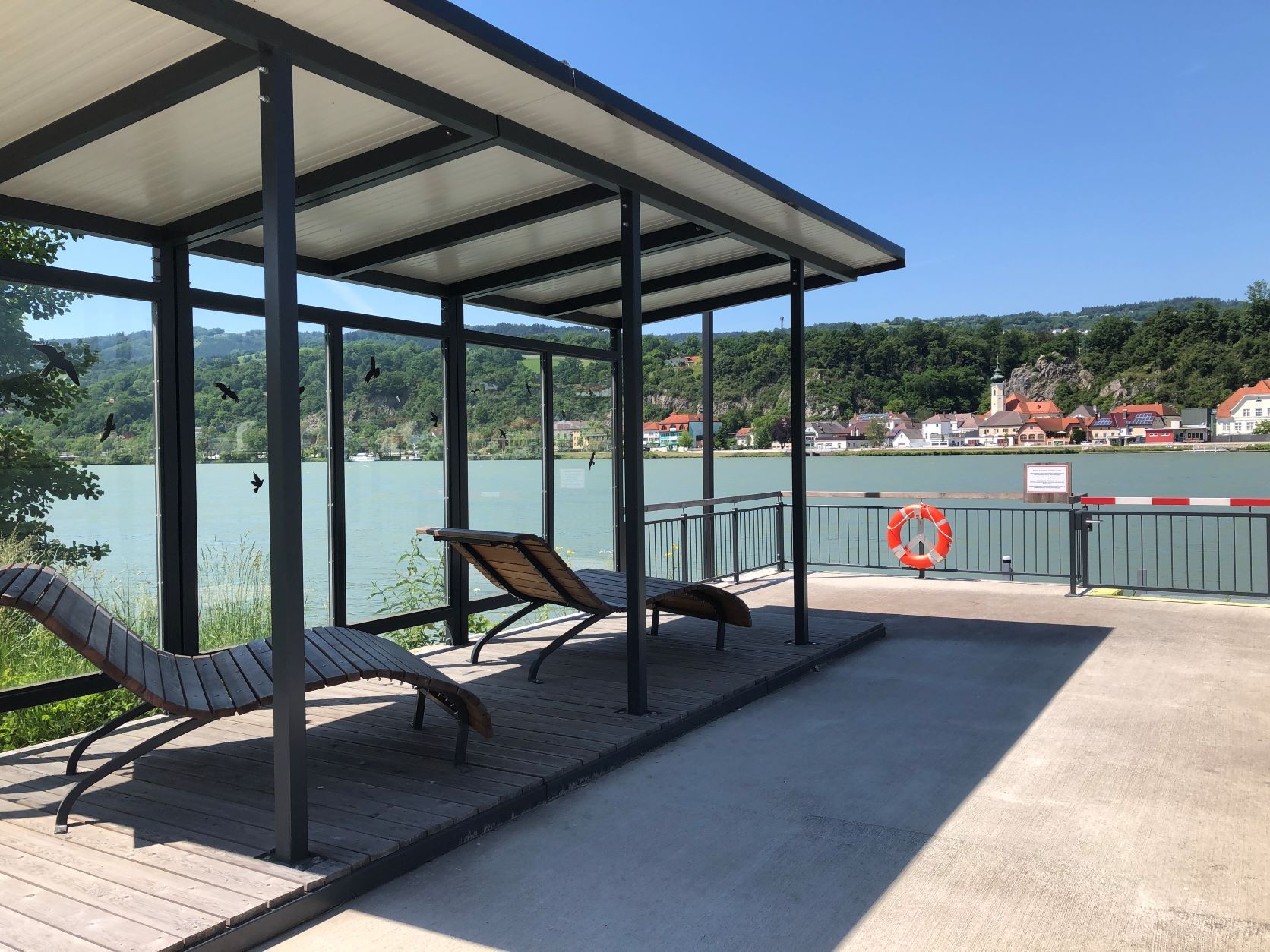 Mooring with deckchairs and views of the river and village.