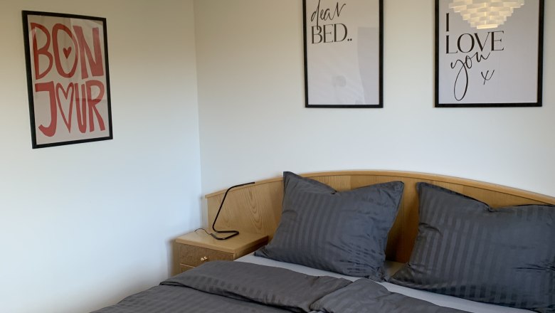 Room with double bed and pictures on the wall