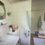 Modern bathroom with washbasin, mirror, towels and decoration.