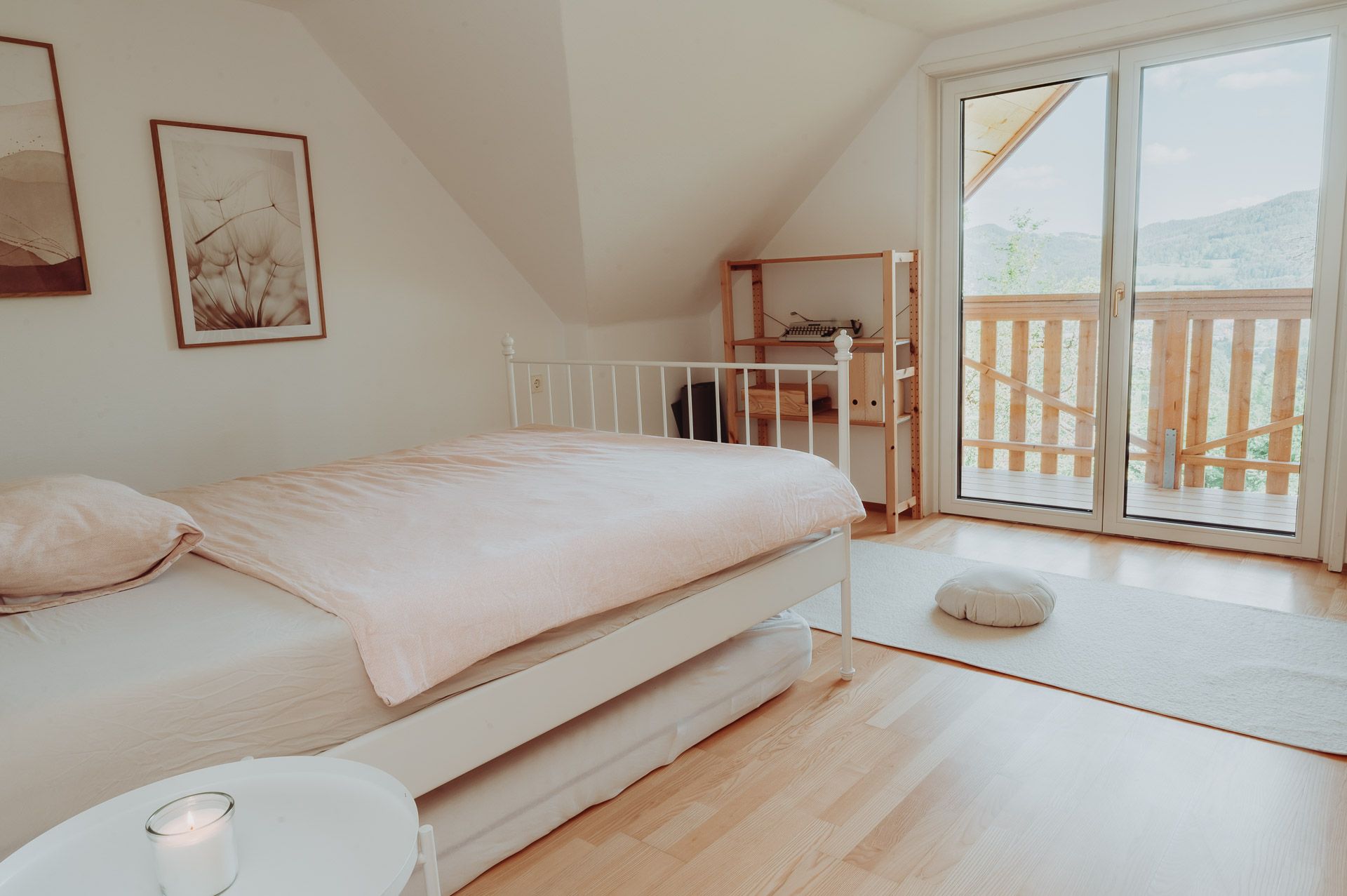 Bright bedroom with bed, balcony and minimalist furnishings.
