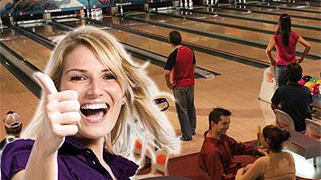 Person showing thumbs up in a bowling center.