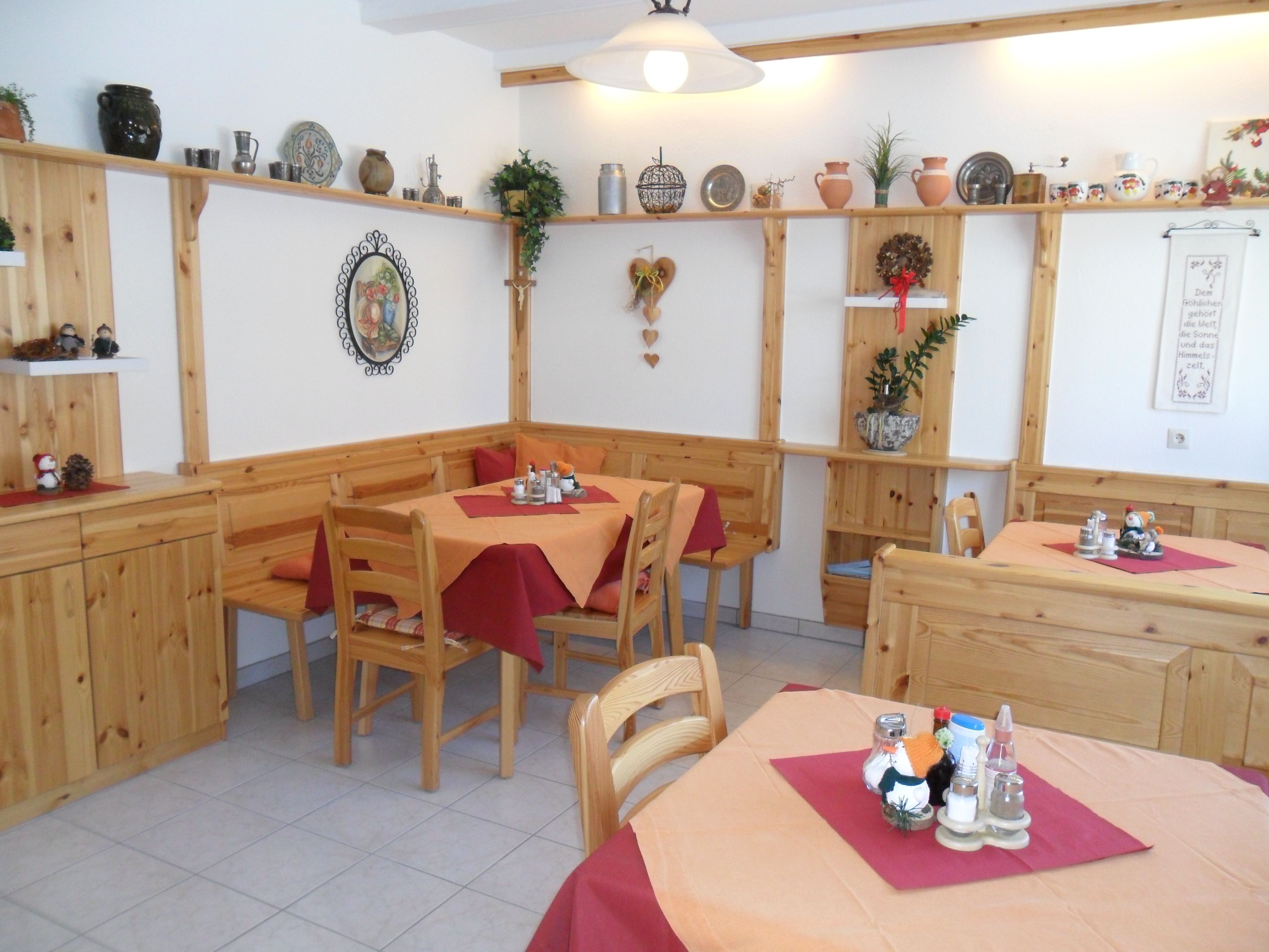 Cozy breakfast room with wooden furniture and decorations on the walls.