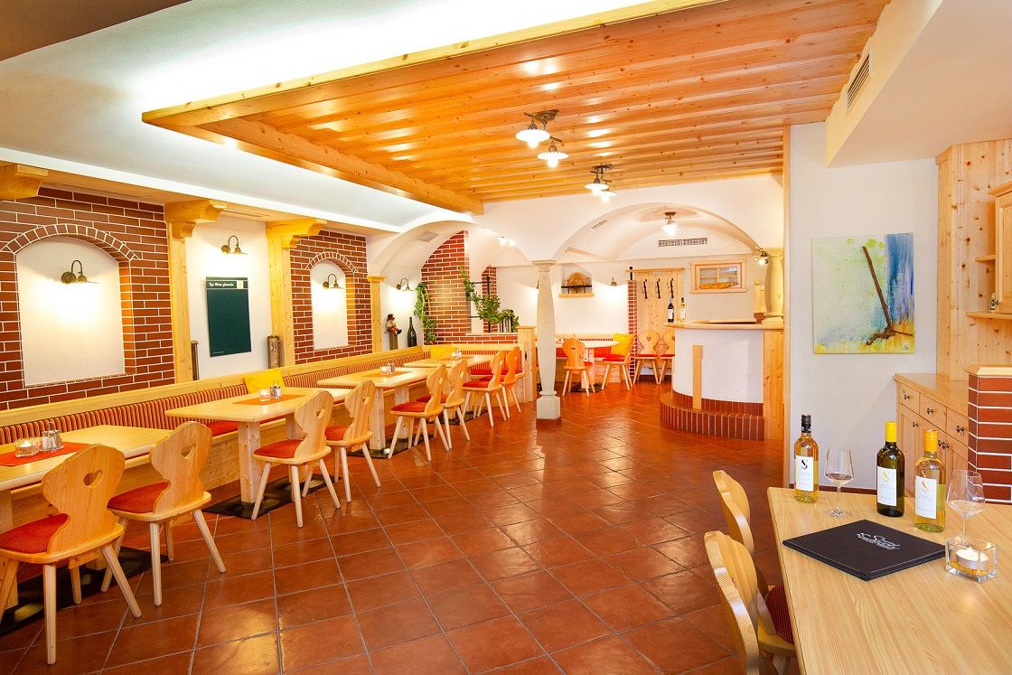 Cozy restaurant with wooden furniture and brick walls.