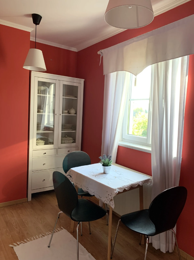 Small kitchen table and sideboard in a red room