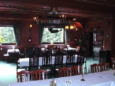 A rustic dining room with wooden furniture and candlesticks.