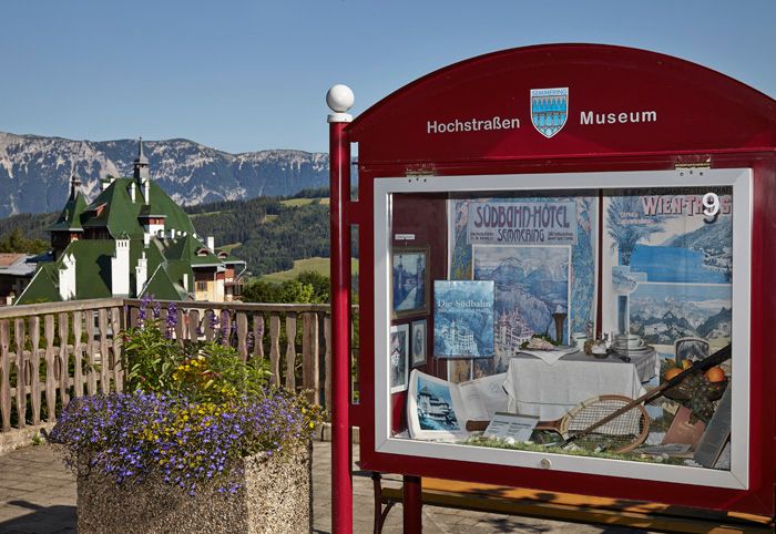 Showcase of the High Road Museum with mountain landscape in the background.