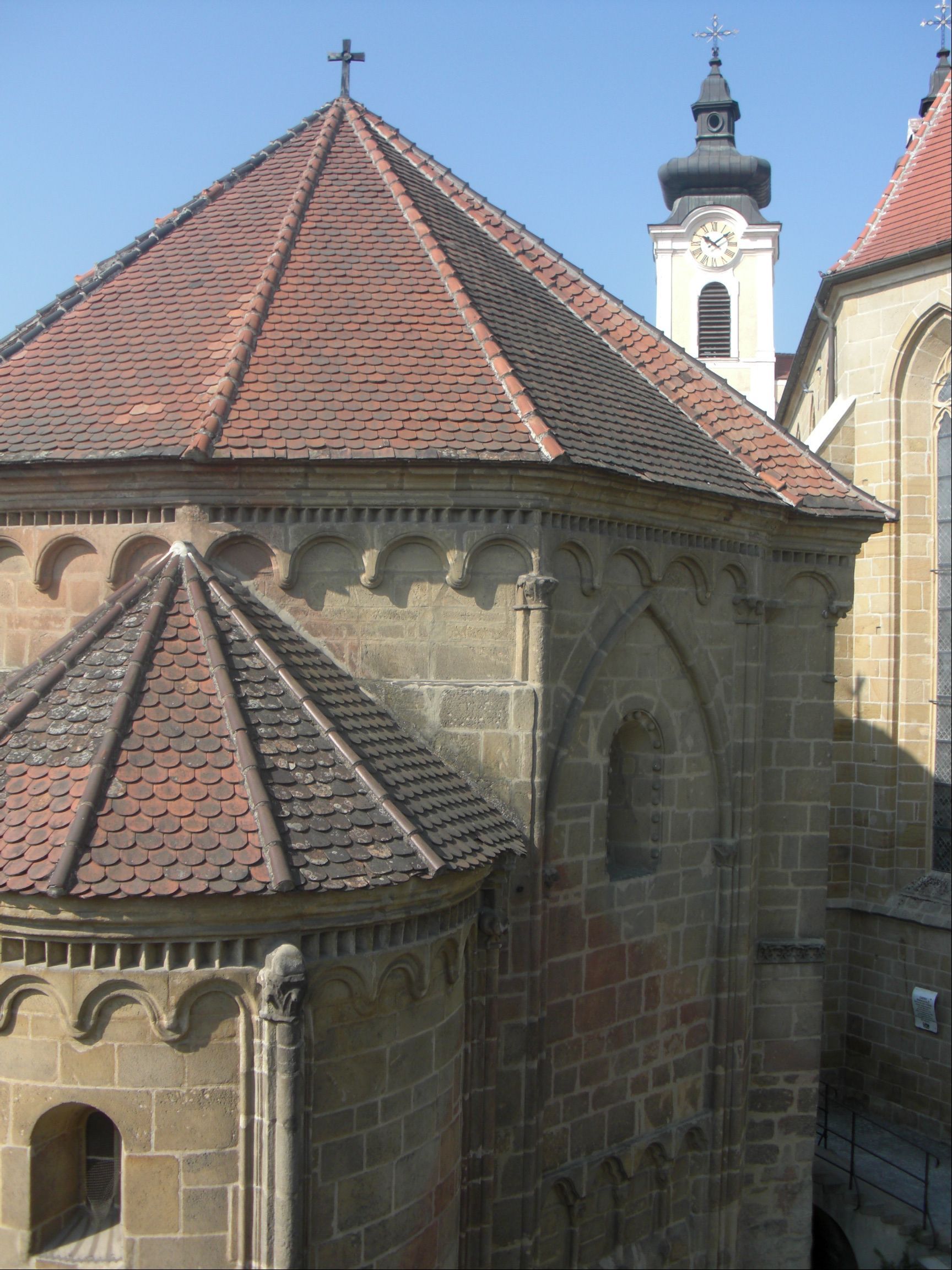 Tulln charnel house with Romanesque architecture and church tower in the background.