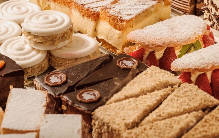 Various cakes and tarts in a patisserie.