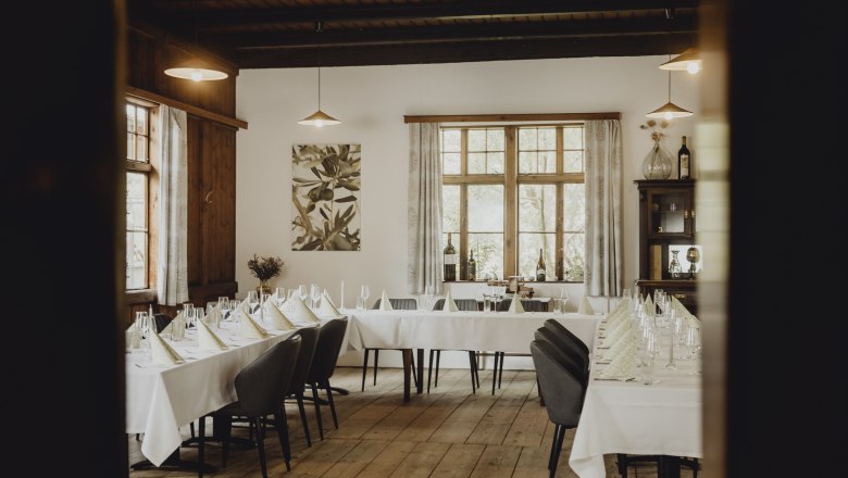 Elegant restaurant with covered tables and wooden floor.