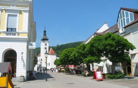 Main square in Purkersdorf with church and stores.