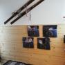 Entrance area with wooden paneling, old skis on the wall and felt slippers in pockets.