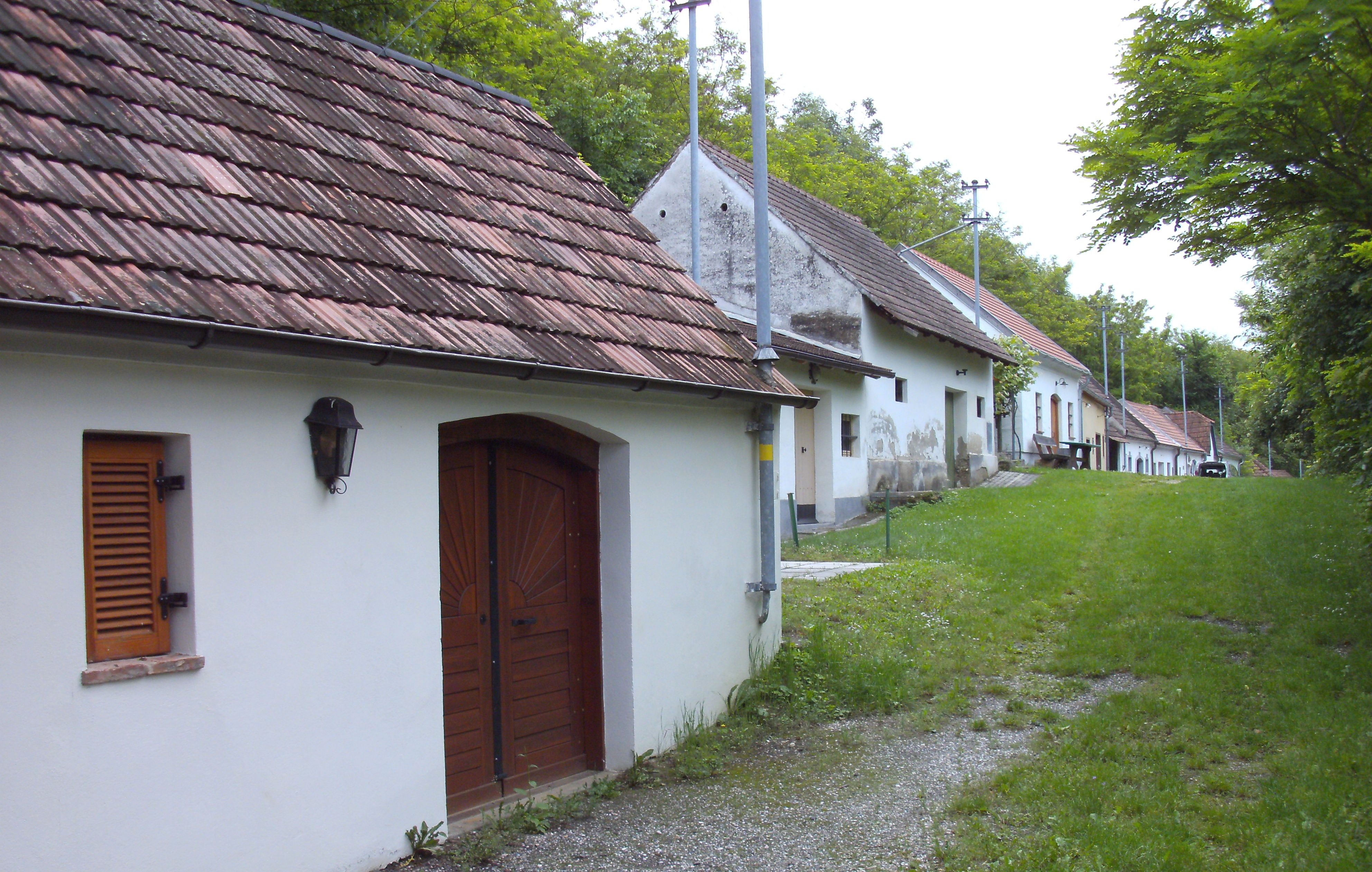 Row of wine cellars in a green setting in Absdorf.