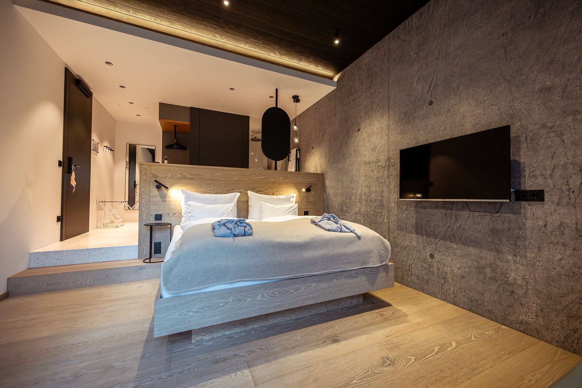 Interior view of a modern restaurant with large windows and a view of wooded hills.