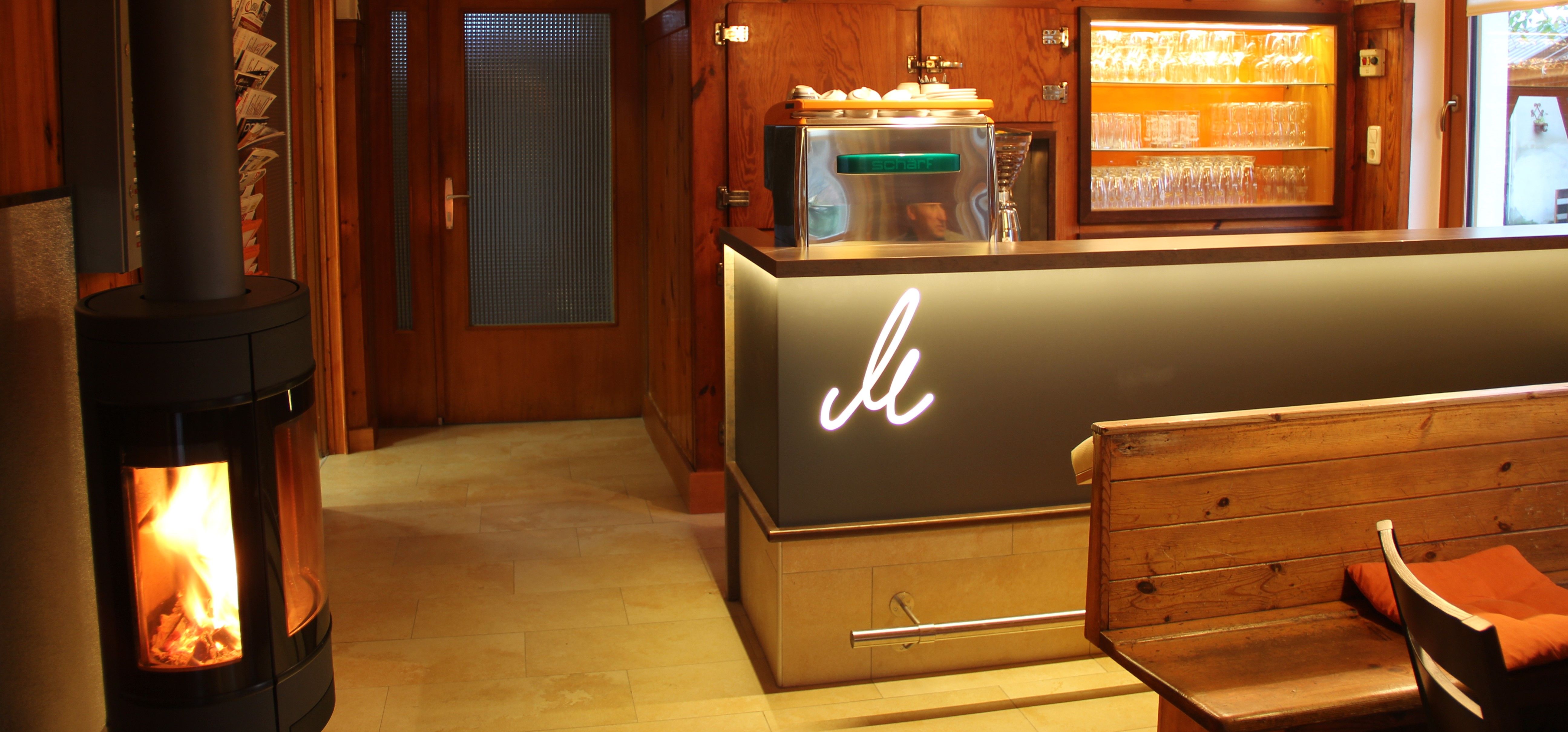 Cozy bar with wooden decor, fireplace and glasses.