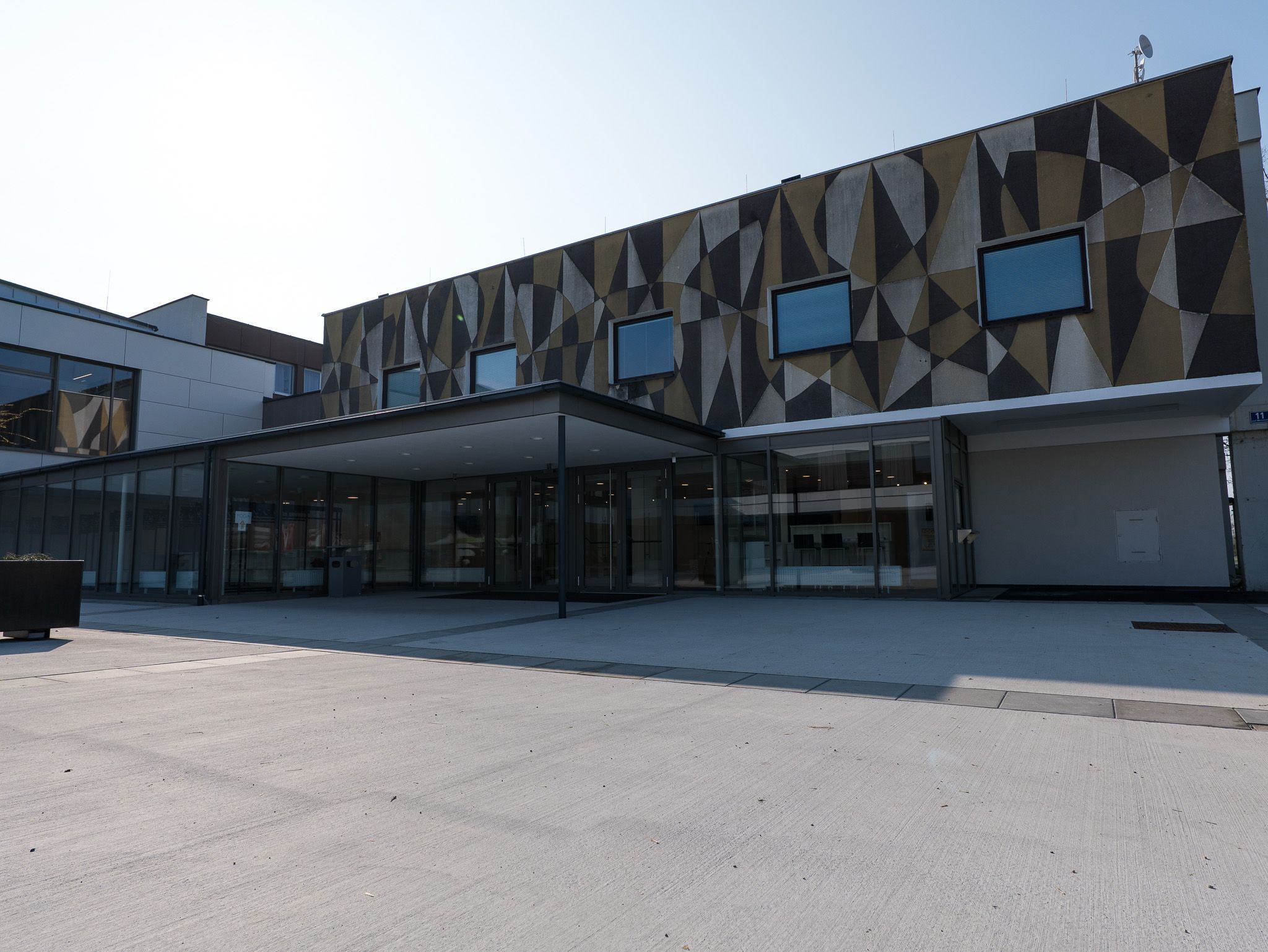 Exterior view of a modern building with geometric patterns on the façade.