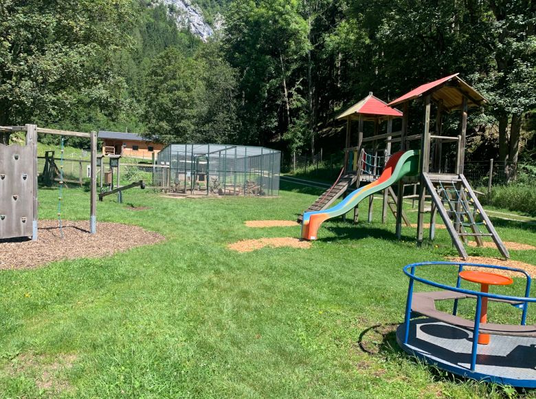 Playground with climbing frame, slide and carousel in the Falkenstein Nature Park.