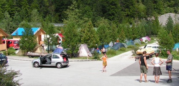 Campsite with tents and people in the open air.