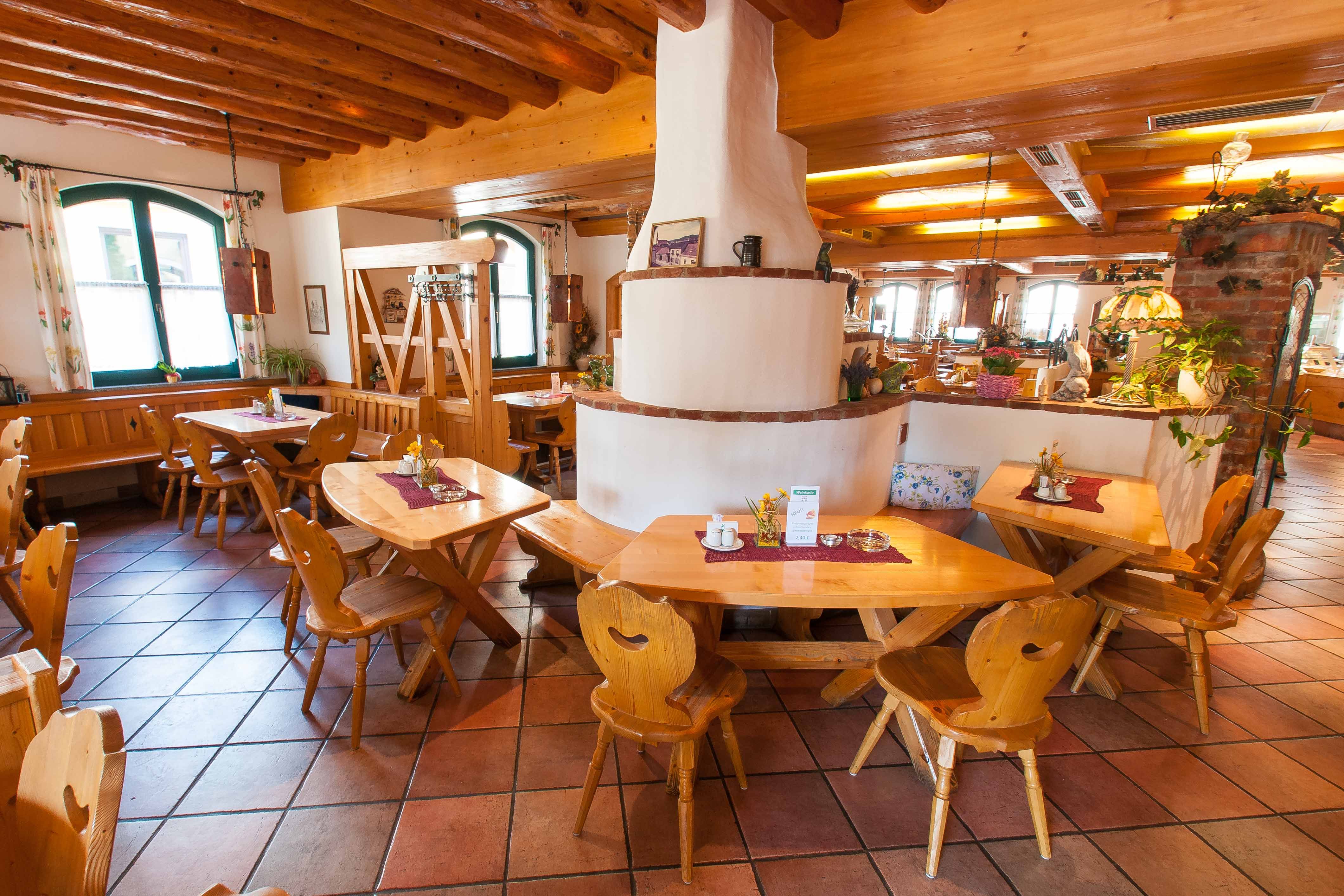 Cozy restaurant with wooden furniture and rustic decor.
