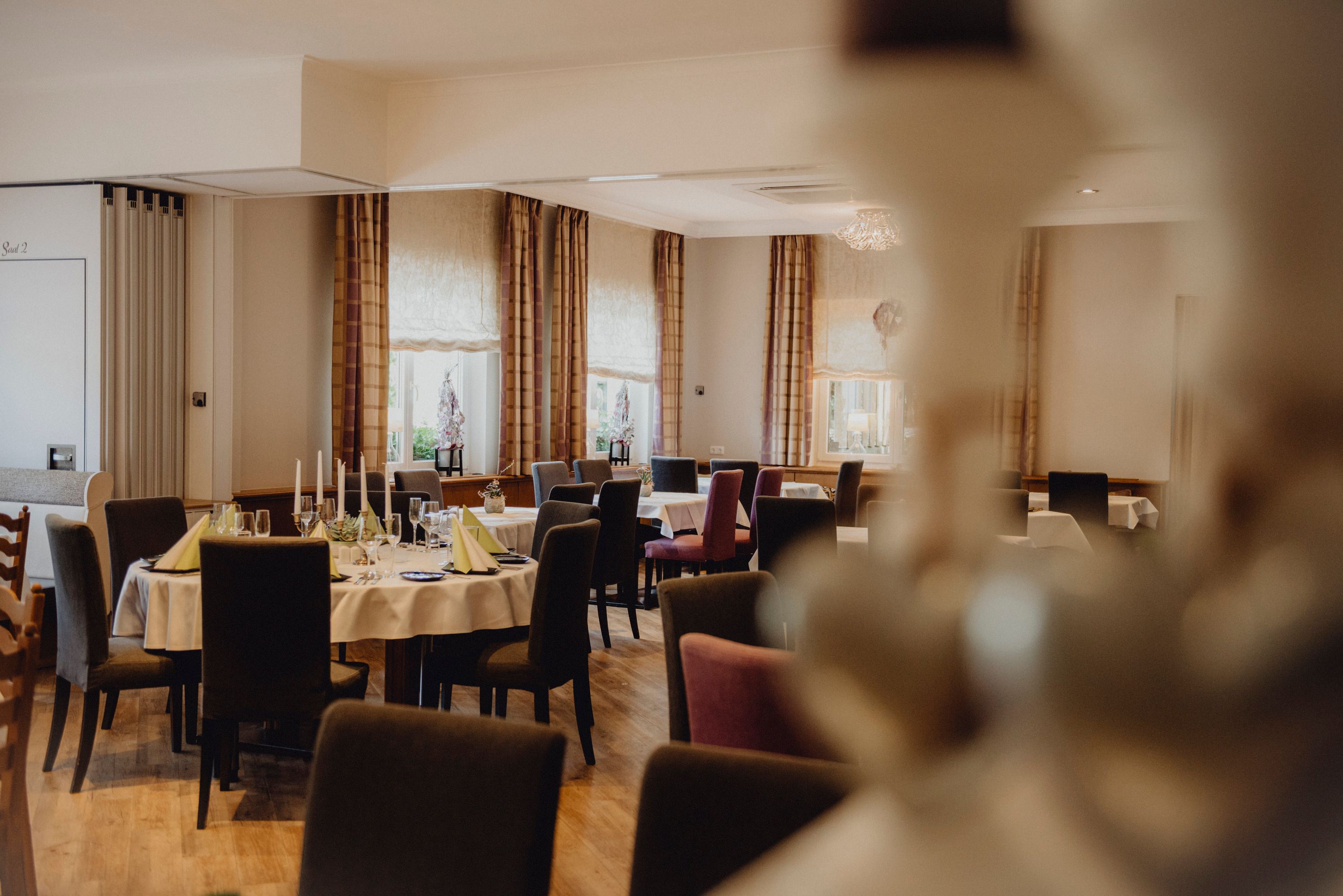 Elegant dining room with laid tables and candles.