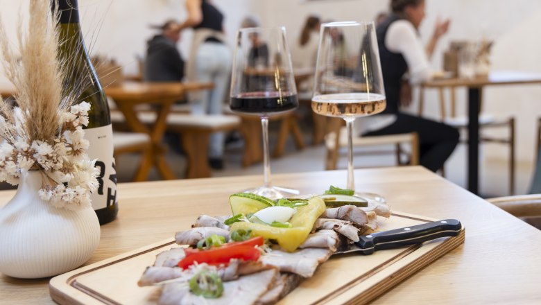 Heurigen snack, wine glasses in the background People