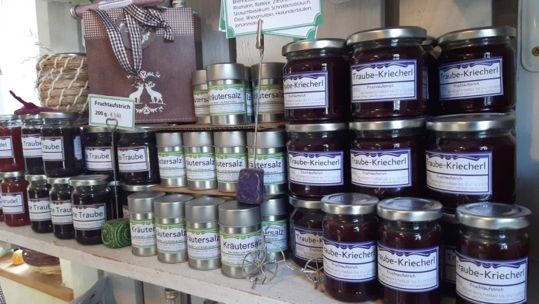 Shelf with jams and herbal salt in a farm store.