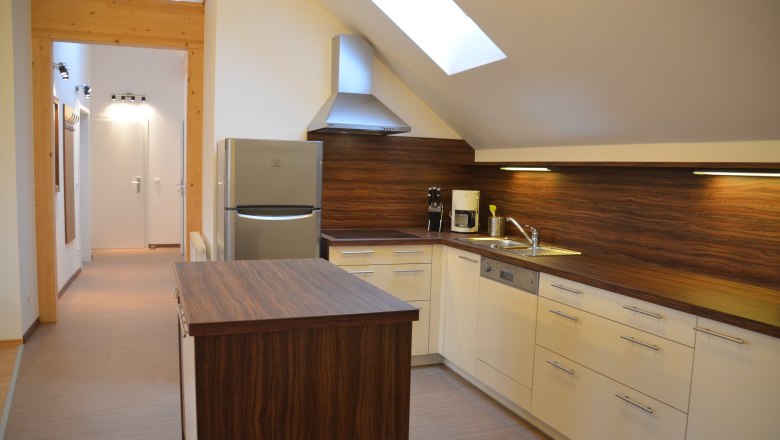 Modern kitchen with wooden worktops, skylight and appliances.