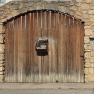 Wooden gate with letterbox and inscription 'Valenta'.