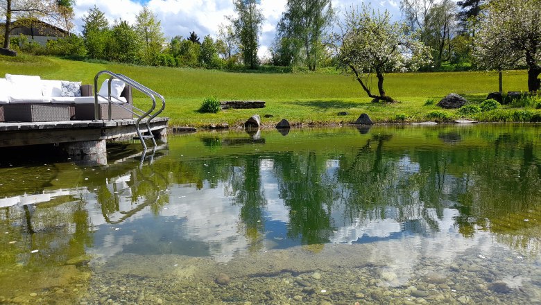 Swimming pond in May with footbridge, &copy; Ferienhaus Angel, Fotograf Heidi Angel